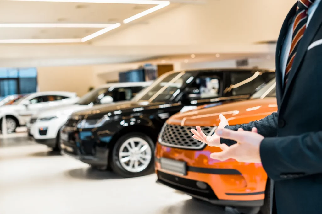 cropped-image-of-male-car-dealer-pointing-by-hands-2024-11-19-06-08-59-utc 1